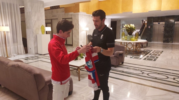 El joven David recibe su camiseta firmada por los jugadores del Granada de manos de Manolo Lucena (FRAN CALVO)
