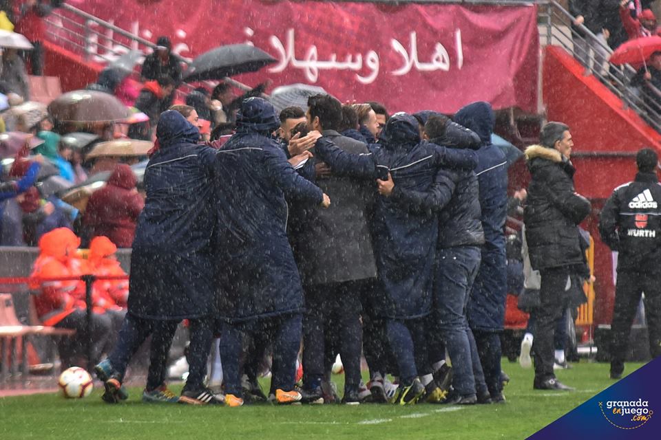 Los jugadores del Granada celebran el gol junto al banquillo (J. M. BALDOMERO)